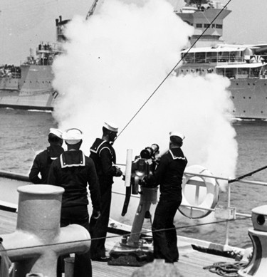 President Franklin D. Roosevelt, embarked on the Indianapolis, receives a 21-gun salute from the Coast Guard Cutter Mojave, during the presidential fleet review off Ambrose Light, New York, 31 May 1934. 