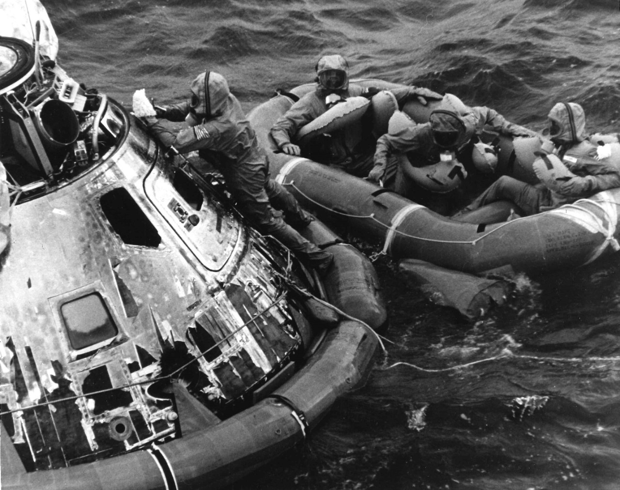 <p>A swimmer from the Underwater Demolition Team seals the Apollo 11&nbsp;Command Module while the three astronauts wait in a raft&nbsp;</p>
