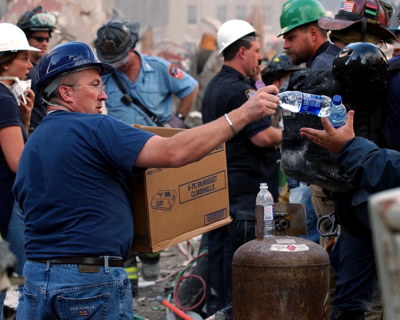Volunteers distribute water to personnel involved in the search and rescue efforts at the World Trade Center, 16 September 2001