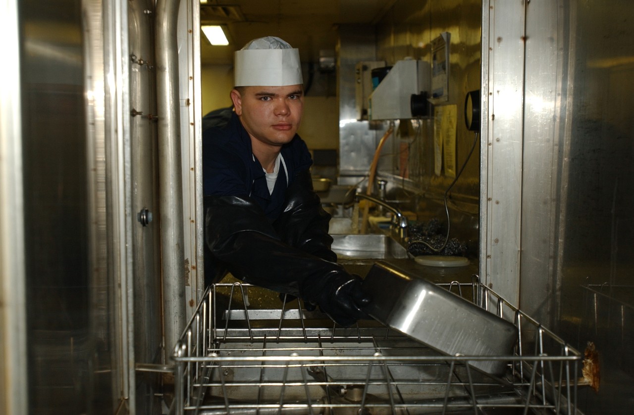 A Hospital Corpsman works in the galley aboard USNS COMFORT (T-AH 20) on 19 September 2001