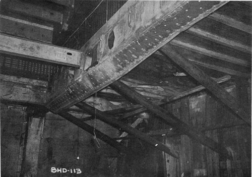 Photo 4: USS ELECTRA - looking forward and to starboard at the shoring for the large patch. Fragment damage to the third deck in way of the hit is also visible.