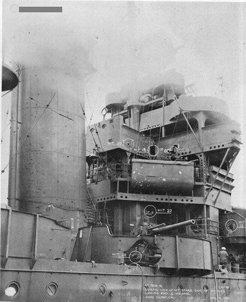 Photo 3: Forward superstructure from starboard side. Note hit on 5" gun No. 3 in foreground and fragment damage to the stack.