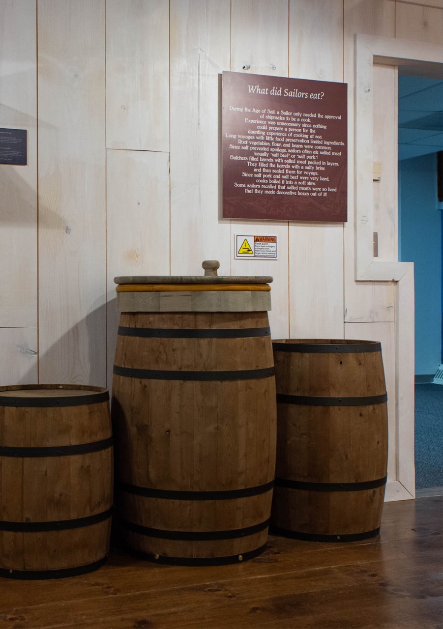 Barrels like those that may have been used on a ship to hold salted meats in a display called, "What did Sailors eat."