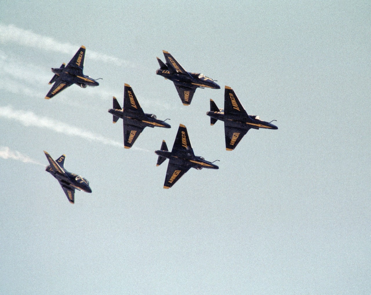 330-CFD-DN-SC-84-09554:  Blue Angels Maneuver:  Delta Head On/Opposing.  A-4F Skyhawk, 1984.   An-air-to-air underside view of A-4F Skyhawk aircraft performing the beginning of a Delta Head On/Opposing Maneuver.   Photographed by PH2 Paul O’Mara.  Official U.S. Navy Photograph.