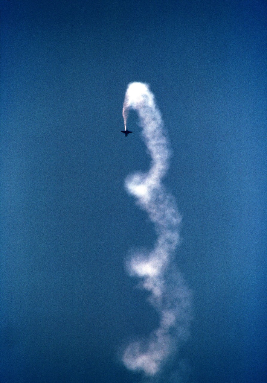 330-CFD-DN-SC-85-00487:  Blue Angels Maneuver:  Vertical Roll.   A-4F Skyhawk II, September 1984.   A Blue Angels Flight Demonstration Squadron A-4F Skyhawk II executes a series of rolls during an air show, September 20, 1984.  Official U.S. Navy Photograph, now in the collections of the National Archives. 
