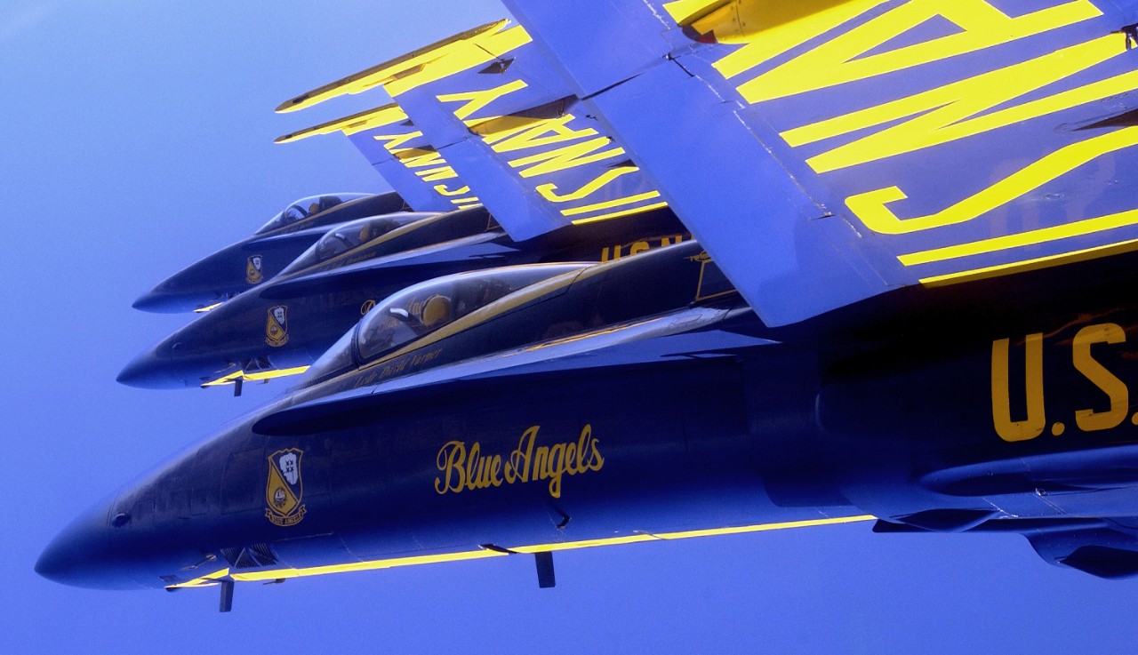 330-CFD-DN-SD-04-10952:   Blue Angels Maneuver:   Tuck Under Break.   F/A-18, October 2003.   Inside the cockpit of a Blue Angel F/A-18 Hornet as the team sets up for the “Tuck Under Break” maneuver during an air show held in San Francisco, California.  While in an echelon formation, the four diamond formation pilots will role their aircraft 270 degrees in ripple fashion, October 10, 2003.  Photographed by PH1 Casey Akins.  Official U.S. Navy Photograph, now in the collections of the National Archives. 