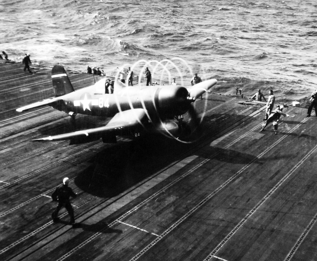 80-G-413974:  Vought F4U Corsair, December 1944.  F4U’s spinning propeller cuts circles of vapors on a damp day in the Pacific as it moves up the deck for take-off against Formosa.  Steichen Photograph Unit, TR-12925.   Photograph released December 1944.   Official U.S. Navy photograph, now in the collections of the National Archives.  