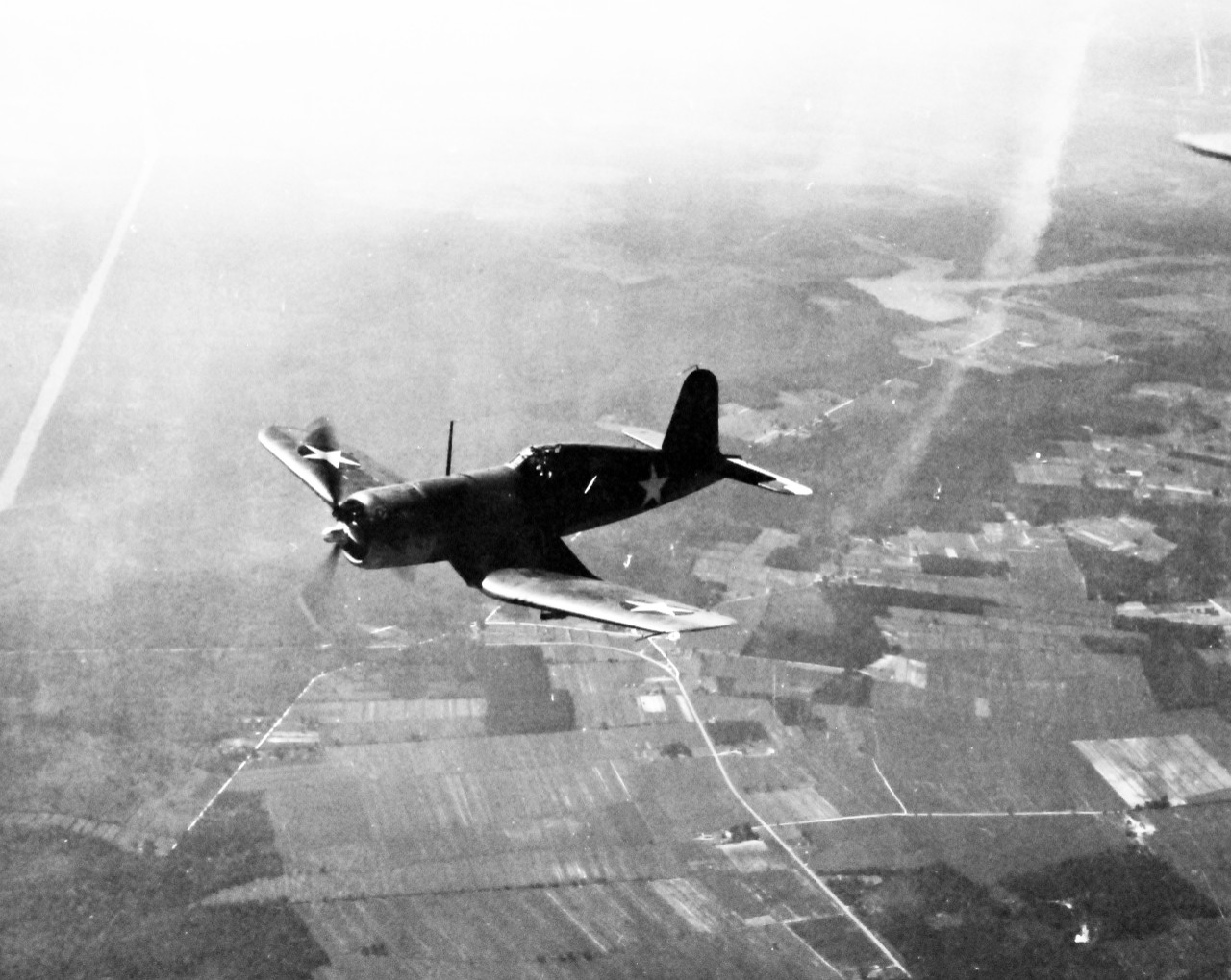 80-G-425100:  Vought F4U Corsair, July 1942.   Corsair in flight over Norfolk, Virginia, July 1942.  Official U.S. Navy Photograph, now in the collections of the National Archives.  