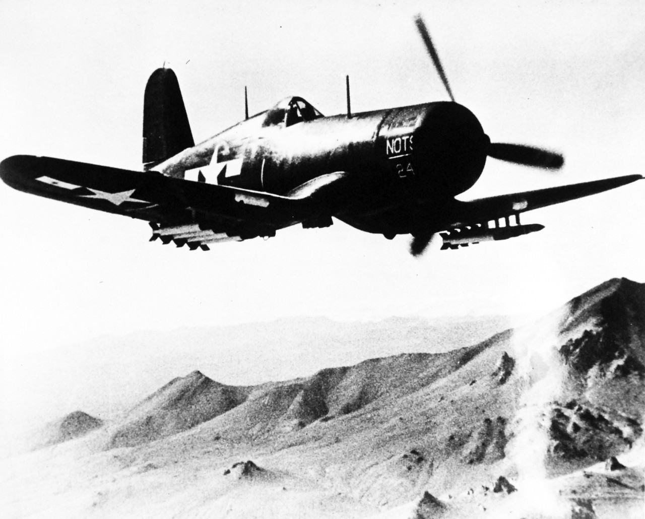 80-G-49315: Vought F4U Corsair, June 1945.  F4U loaded with rockets from Naval Ordnance Test Station, Inyokern, California, June 5, 1945.  Shown:  Plane loaded with eight 5” rockets roars out to testing range.    Official U.S. Navy Photograph, now in the collections of the National Archives.  