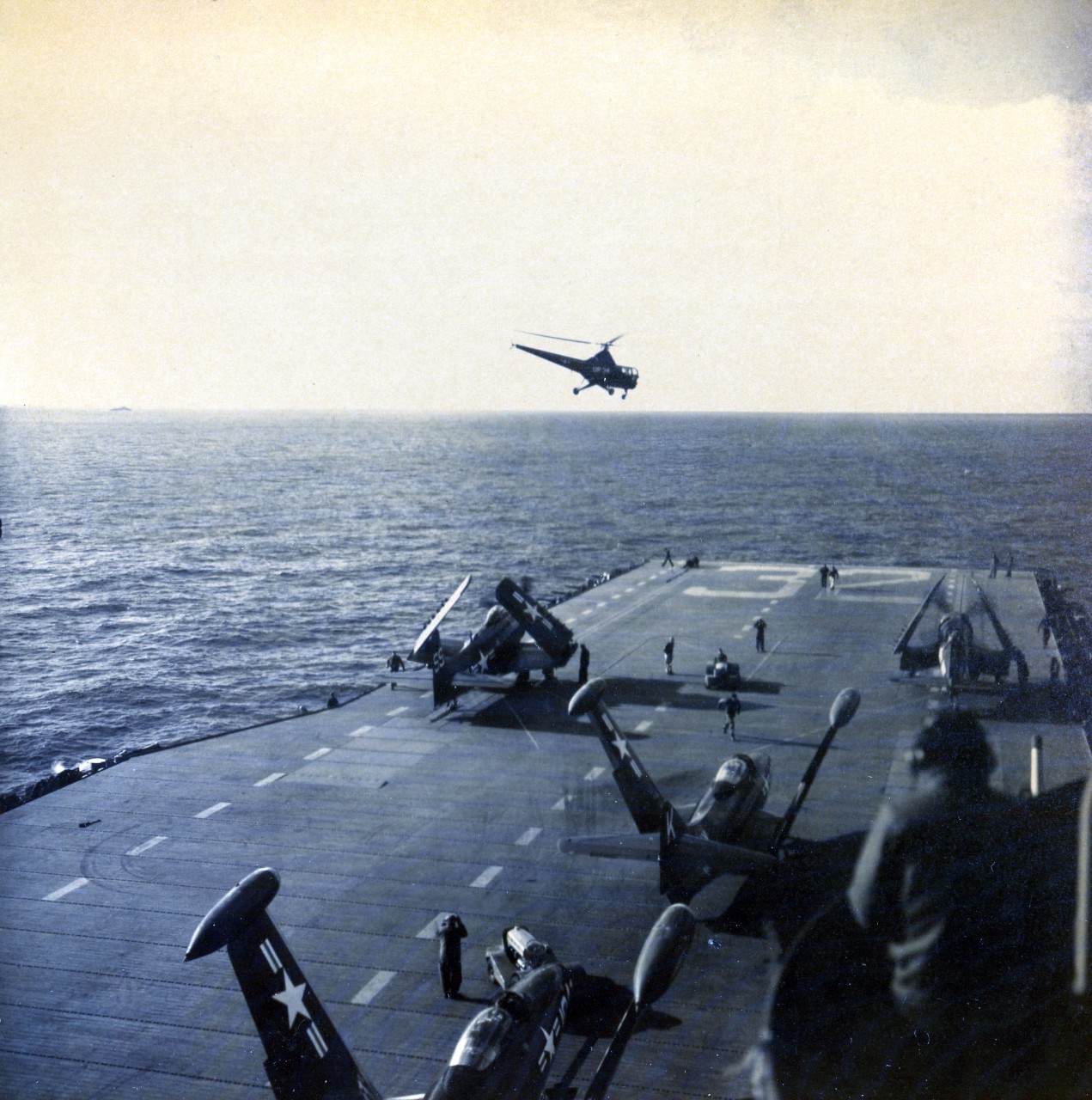 80-G-K-11877:   Grumman F9F Panthers, May 1951.   Two F9Fs “Panther” Jets are catapulted on board USS Leyte (CV 32) in Korean Waters.  Note, helicopter in flight over ship, 21 May 1951.   US Navy photograph, now in the collections of the National Archives.  