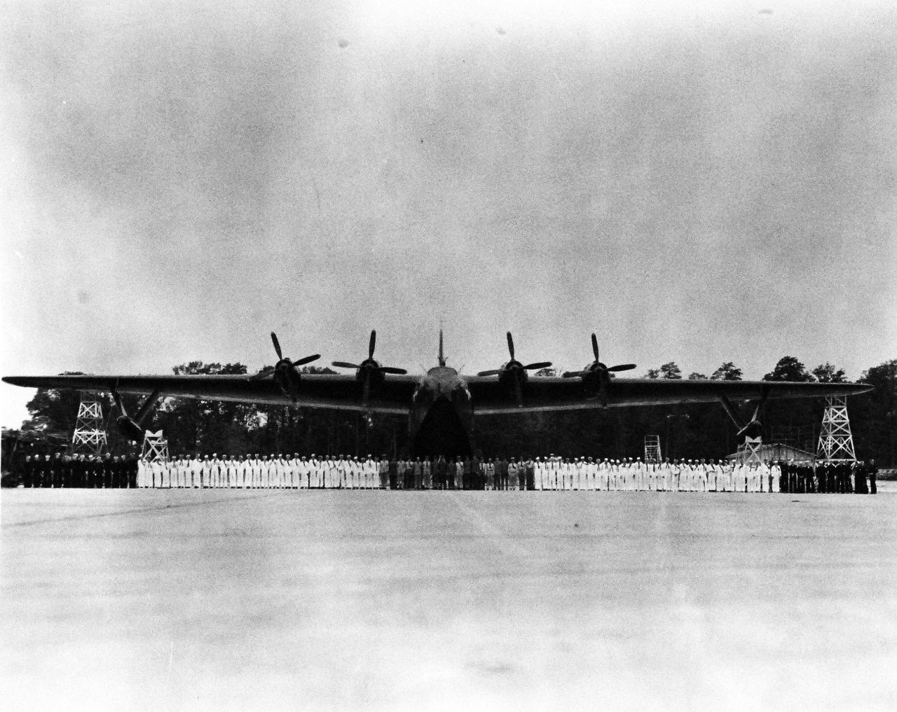 80-G-700052: JRM (Hawaiian Mars, BuNo 76819), July 1945.   The World’s Largest Flying boat which the Glenn L. Martin built for Naval Air Transportation Service (NATS), was launched at conclusion of ceremonies held at the company’s Strawberry Point Seaplane Base. Launching day coincided with the graduation exercises for future flight and ground crews of the new transports officers and men beside plane. Photograph, July 21, 1945. Official U.S. Navy photograph, now in the collections of the National Archives. 