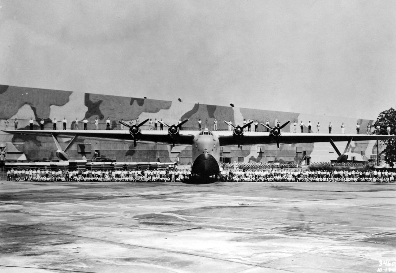 LC-Lot-3465-5: Martin JRM “Mars” aircraft, XPB2M-1, 1941. Original caption, “Mistress of the Air and Some of those Who Built Her.” The mighty Martin Mars, 70-ton Navy flying boat and the biggest ship of her type in the world, forms a background for part of the Experimental crew that built her. Thirty-five men, spaced about six feet apart, stand along her 200-foot wing and 215 other persons are grouped before the ship. Announcement of the Mars’ conversion into the world’s largest air cargo carrier was made recently by Glenn L. Martin, President of the Glenn L. Martin Company and pioneer developer of huge flying boats. Glenn L. Martin Company, 1941-45. Courtesy of the Library of Congress. 