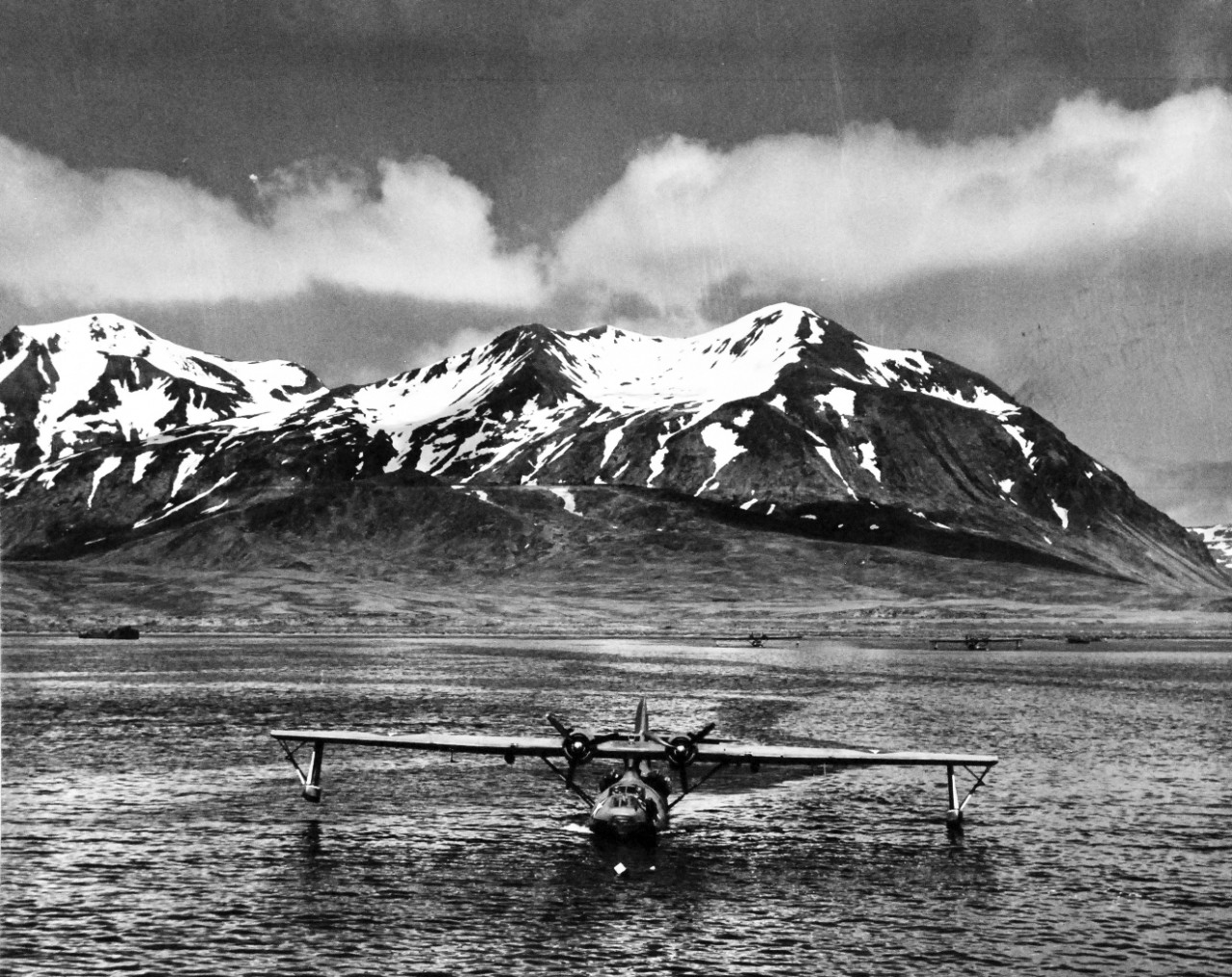 80-G-475733:   PBY-5 “Catalina” patrol bomber, July 1943.   PBY-5 anchored near seaplane tender in Attu Harbor in Aleutians  Photographed by Lieutenant Horace Bristol, July 1943.  TR-5224.   U.S. Navy photograph, now in the collections of the National Archives.  (2015/11/17).