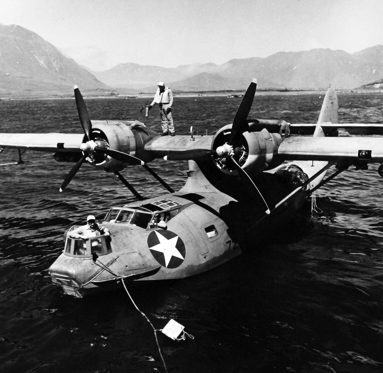80-G-475771:   PBY-5 “Catalina” patrol bomber, July 1943.   PBY-5 crew member stands by with extinguisher while motors are started on a Consolidated PBY “Catalina” aircraft near USS Casco (AVP 12) at Attu, Aleutian Islands.   Photographed by Lieutenant Horace Bristol, July 1943.   TR-5374.   U.S. Navy photograph, now in the collections of the National Archives.  (2015/11/17).