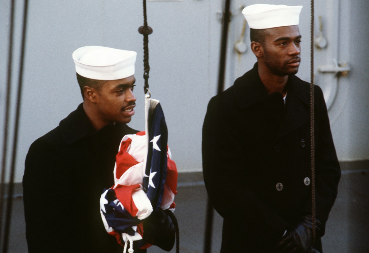 330-CFD-DN-ST-87-02591:   USS Missouri (BB-63), 1986.   Crew members prepare to raise the ensign during morning colors aboard the battleship USS Missouri (BB 63).  The ship is on an around-the-world shakedown cruise, 1986.  Official U.S. Navy Photograph, now in the collections of the National Archives.   