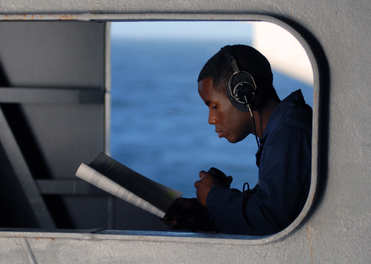 071020-N-7981E-106:  Yeoman Seaman Ernest Matthews, October 2007.  Yeoman Seaman Ernest Matthews studies advanced qualifications while standing by to relay messages using a sound- powered phone as the Nimitz-class aircraft carrier USS Abraham Lincoln (CVN-72) approaches the fleet replenishment oiler USNS Henry J. Kaiser (T-AO 187). Lincoln is underway for a scheduled workup to include Composite Training Unit Exercise (COMTUEX), an exercise designed to enhance the interoperability of the carrier and its strike group. Mass Communication Specialist 3rd Class James R. Evans  Photographed on October 20, 2007 by Mass Communication Specialist 3rd Class James R. Evans.  Official U.S. Navy photograph. 