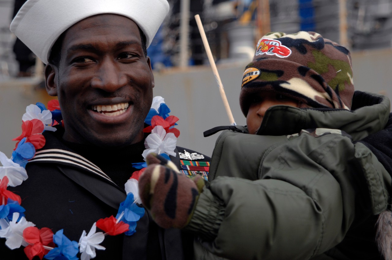 071219-N-5292M-044:   Culinary Specialist 1st Class Robert Scott,  December 2007.   Scott, from the destroyer USS James E. Williams (DDG-95), greets his son after returning to Naval Station Norfolk, Va., Dec. 19, 2007.  James E. Williams, part of the Enterprise Carrier Strike Group, is returning from a six-month deployment in support of maritime security operations.  Photographed by Mass Communication Specialist 2nd Class Julie Matyascik.  Official U.S. Navy Photograph.  
