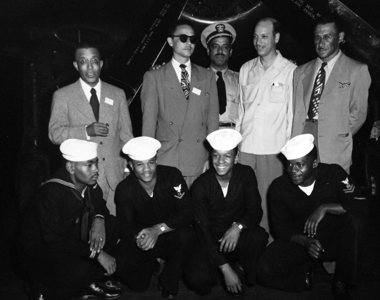80-G-413549:   USS Midway (CVA-41), October 5, 1949.   Correspondents on board the aircraft carrier.  Back row, (left to right):  Mr. C. Murphy; MR. R. Ratcliff; Lieutenant D.D. Nelson; Mr. T.W. Young; and Mr. D. H. Davis.  Front row, (left to right): ABAN F.A. Epps; RD3 J.E. Dulaney; SN H.N. Turner; and BM2 J.J. Pratt.   Official U.S. Navy Photograph, now in the collections of the National Archives.  