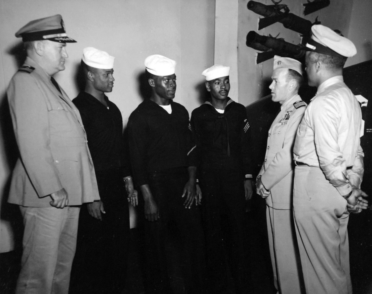 80-G-413551:   USS Midway (CVA-41), October 5, 1949.   U.S. Naval Officers and men, (left to right):  Commander T. H. Reilly, ChC; RD3 J.E. Dulaney; BM2 J.J. Pratt; ABAN F.A. Epps; Captain J.H. Flatley; and Lieutenant Dennis D. Nelson.   Nelson was one of the Golden Thirteen.  Official U.S. Navy Photograph, now in the collections of the National Archives.  