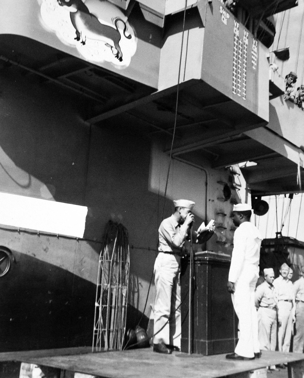 208-NP-King:   Steward's Mate Second Class Ed King, October 1944.  Captain H.W. Taylor of USS Cowpens (CVL-25) presents commendation to Steward’s Mate Second Class Ed King, October 1944. Official U.S. Navy photograph, now in the collections of the National Archives.   