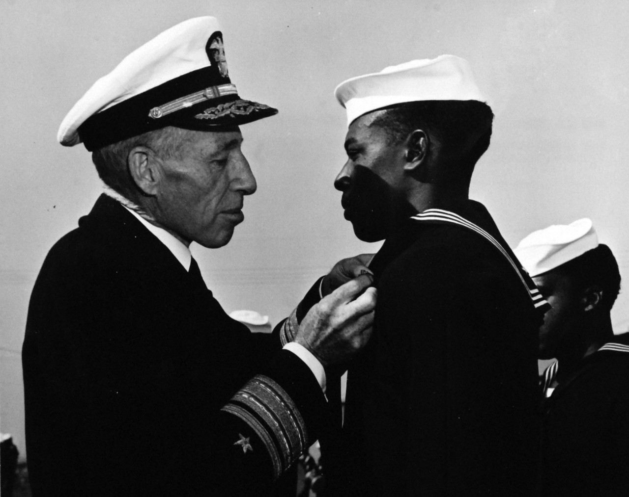 80-G-47280:  Seaman First Class William E. Anderson, USNR, 1944.  Rear Admiral Carleton H. Wright presenting the Navy and Marine Corps Medal to Seaman First Class William E. Anderson, USNR.  Received the medal for risking his life to bring flames under control during the Port Chicago Magazine, California, explosion and fire.    Photograph filed December 9, 1944. Official U.S. Navy photograph, now in the collections of the National Archives.   