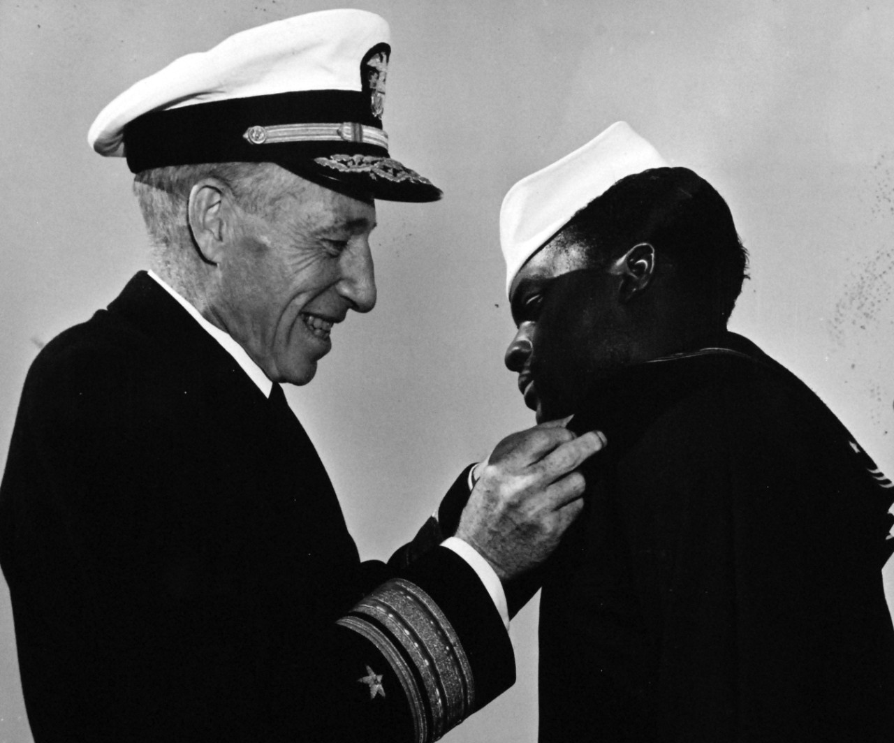 80-G-47281:  Seaman First Class James A. Camper, USNR, 1944.  Rear Admiral Carleton H. Wright presenting the Navy and Marine Corps Medal to Seaman First Class James A. Camper, USNR.  Received the medal for risking his life to bring flames under control during the Port Chicago Magazine, California, explosion and fire.    Photograph filed December 9, 1944. Official U.S. Navy photograph, now in the collections of the National Archives.   