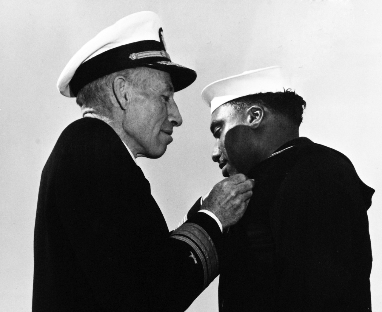 80-G-47283: Seaman First Class Richard L. McTere, USNR, 1944.   Rear Admiral Carleton H. Wright presenting the Navy and Marine Corps Medal to Seaman First Class Richard L. McTere, USNR.  Received the medal for risking his life to bring flames under control during the Port Chicago Magazine, California, explosion and fire.   Photograph filed December 9, 1944. Official U.S. Navy photograph, now in the collections of the National Archives.   