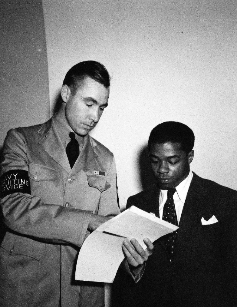 208-NP-8B-1:  William Baldwin, June 1942.    Baldwin was the first U.S. Navy African American recruit being assisted by a U.S. Navy Recruiting Service member, June 2, 1942.   Official U.S. Navy photograph, now in the collections of the National Archives.