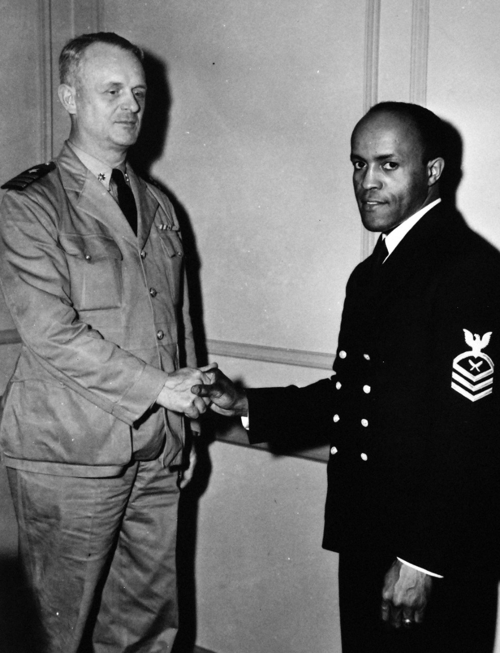 80-CF-882-4_Box 175:   Chief Yeoman F.L. Walker, 1942-1943.  African-American enters Navy as Chief Specialist.  Commander B.B. Ralston, USN (Ret.), Inspector of Naval Recruiting, Northeastern Division, congratulates Chief Yeoman F.L. Walker, USNR, 1942-19843.   Official U.S. Navy photograph, now in the collections of the National Archives.