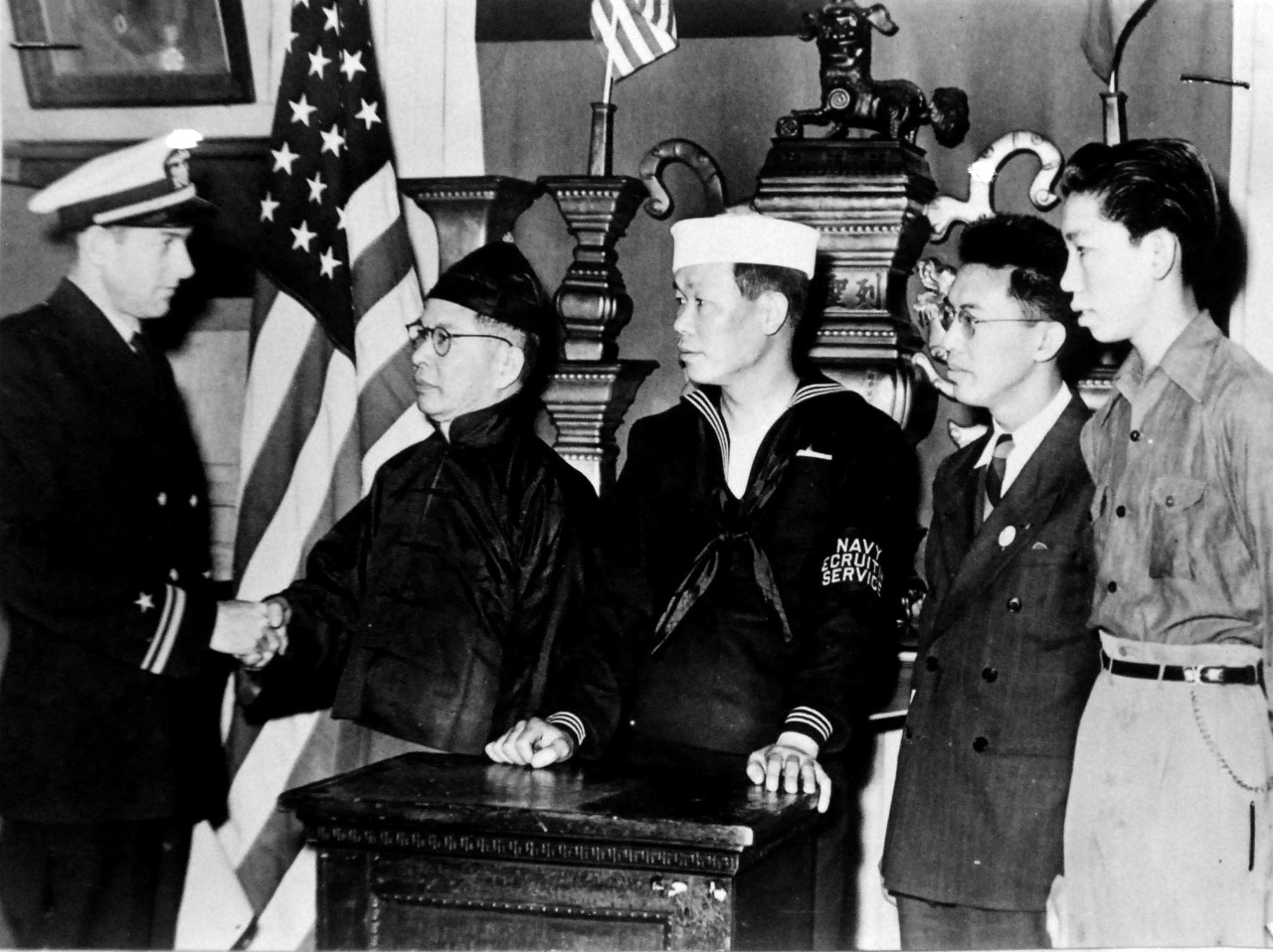 LC-Lot 9431-15:  Chinese Join U.S. Navy, circa WWII.   A Navy Recruiting Station has been opened at the Chinese Consolidated Benevolent Association’s Headquarters in Los Angeles to enlist Chinese youths for service in the U.S. Navy, circa 1942.  Shown at opening ceremonies are, (left to right), Lieutenant Roger D. Trick; Reverend K.N. Leong; Clarence Yeu, Chinese Recruiter; Billy Lew and Henry Quon.  Office of War Information photograph. Courtesy of the Library of Congress.  