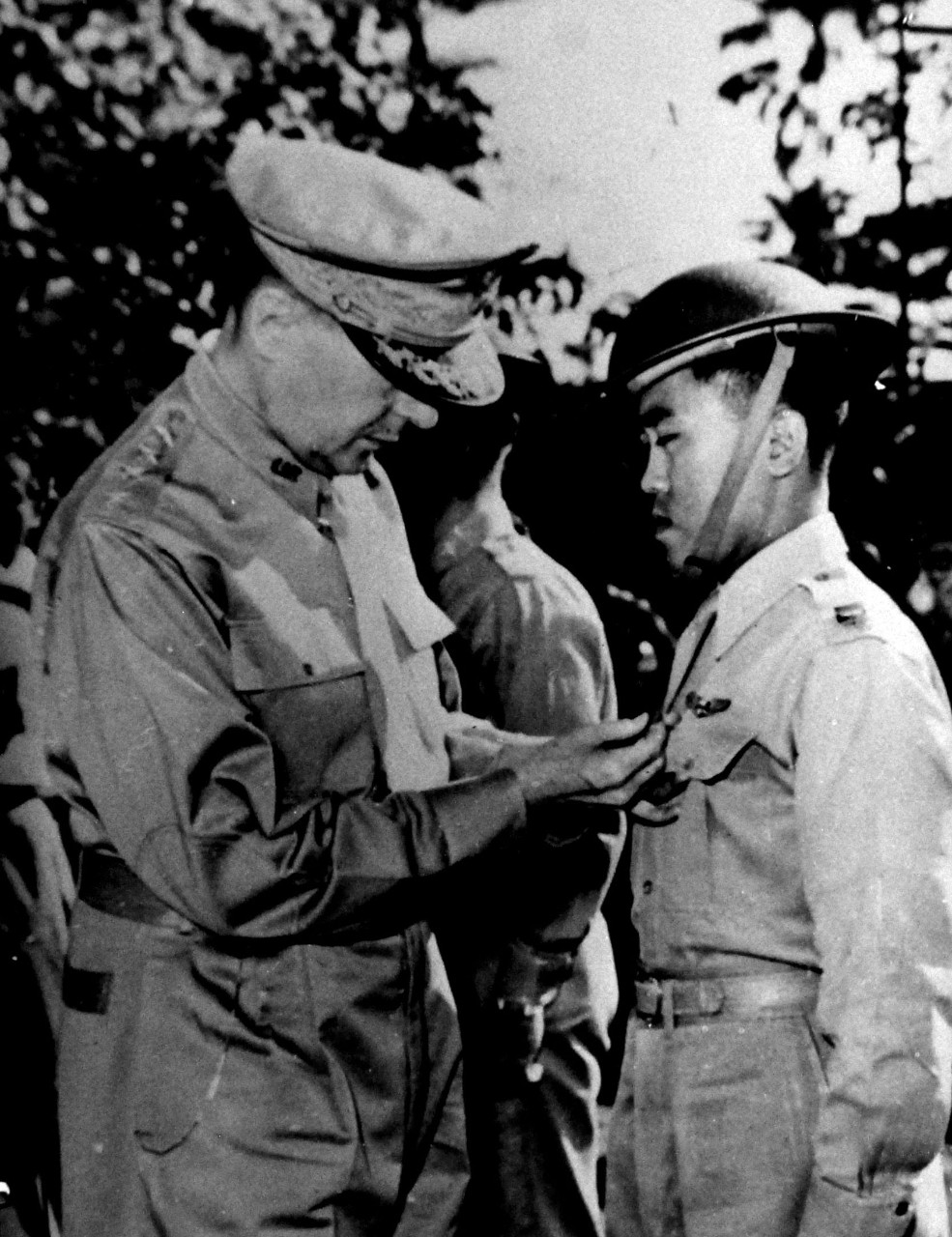 LC-Lot 9431-18:  Heroes of the Philippines, December 1941.  General Douglas MacArthur pins the Distinguished Service Cross on a member of his forces – Captain Jesus Villamor, the first Filipino hero to receive the high award.  This picture, taken soon after the Japanese invasion, is among the first photographs received of action during the war in the Philippines.  The Distinguished Service Cross is the U.S. Army’s version of the Navy Cross.  Villamor received the award for his actions in December 1941. The Philippines would fall in the spring of 1942 to the Japanese, and U.S. would not return until  October 1944.   The U.S. Navy would play a vital part in returning the Philippines back to the Allies.   Office of War Information photograph. Courtesy of the Library of Congress.  