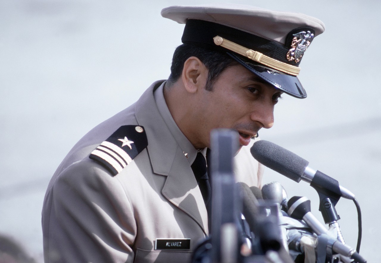 330-CFD-DD-ST-99-04354:  Lieutenant Commander Everett Alvarez, February 1973.   Alvarez, captured August 5, 1964 talks at the microphones to the public and press there to greet the plane load of former POWs flown in from Clark Air Base. LCDR Alvarez was released by the North Vietnamese in Hanoi on February 12, 1973.  Photographed by SSGT Phillip M. Porter. Official Department of Defense photograph, now in the collections of the National Archives.  