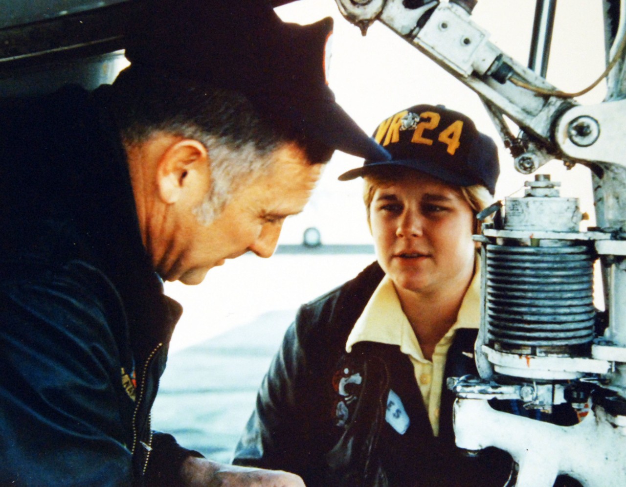428-GX-K-105739:  Ensign Jane M. Skiles, November 1974.   Rota, Spain.  Master Chief Air Controlman Ron K. Jones, (left), last enlisted pilot in the Navy and Ensign Jane M. Skiles, woman pilot assigned to Fleet Tactical Support Squadron 24, (VR-24), make pre-flight checks of the nose landing gear of a US-2B Tracker antisubmarine aircraft at U.S. Naval Station, Rota, Spain   Photographed by PHAN F.D. Adams, November 1974.   Official U.S. Navy Photograph, now in the collections of the National Archives.  