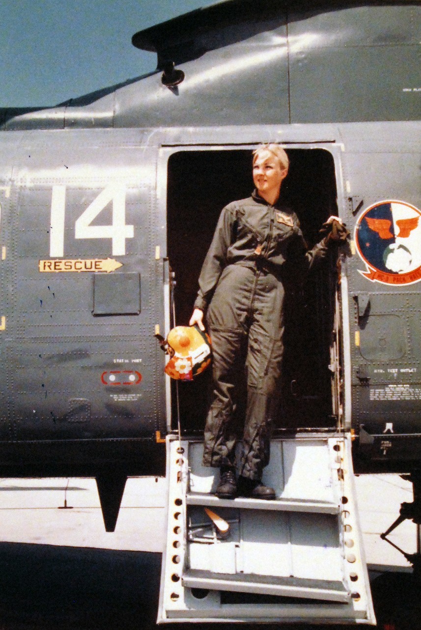 428-GX-K-108379:  Ensign Joellen Brag, May 1975.  She is the Navy’s first woman helicopter co-pilot, stands in a doorway of one of the CH-46D “Sea Knight” helicopters of her squadron, Helicopter Support Squadron Three, HC-3.  Photographed by JO3 Susan Fisher at Naval Station North Island, California, May 9, 1975.     U.S. Navy Photograph, now in the collections of the National Archives.  