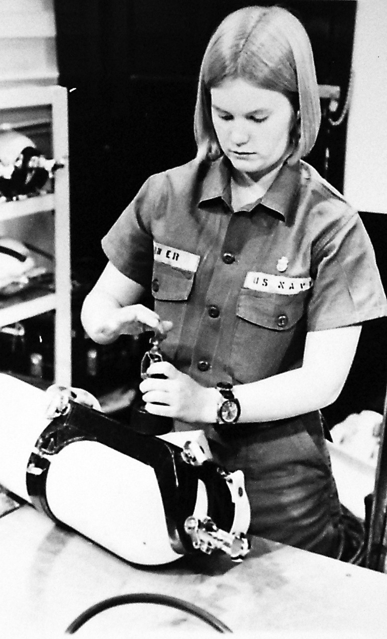 428-GX-USN 1158673:  Personnelman Seaman (DV) Nancy Garner, March 1974.     Garner prepares a scuba bottle for her next dive at Naval Air Station, North Island, California.    Garner is the first female Navy diver.  Photographed by AN Harold Brown, March 23, 1974.   Official U.S. Navy Photograph, now in the collections of the National Archives. 