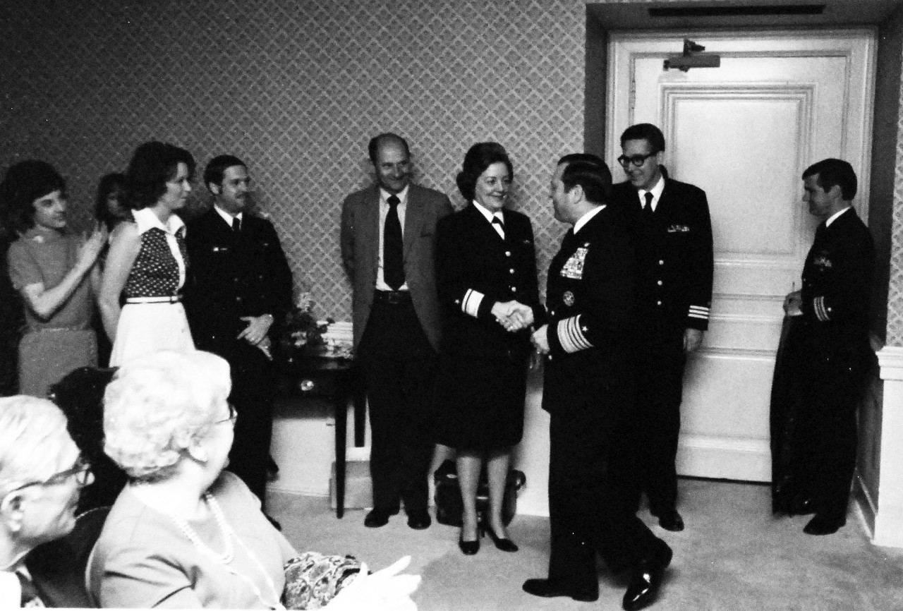 428-GX-USN 1166664:  Rear Admiral Fran McKee, May 1976.   Admiral James L. Holloway, III, (right center), Chief of Naval Operations, congratulates Rear Admiral Fran McKee at the conclusion of her frocking ceremony at the Pentagon. Photographed by David Wilson, May 5th, 1976.  She was the first female line officer to hold the rank of Rear Admiral in the U.S. Navy.   Official U.S. Navy photograph, now in the collections of the National Archives. Photographed from small reference card.    