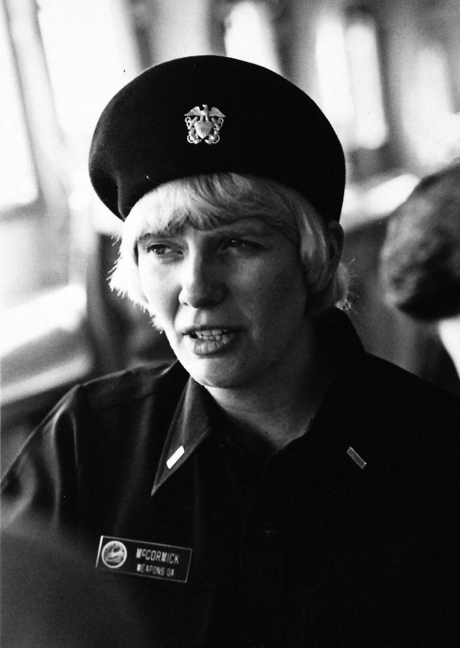 428-GX-USN 1173631:  Ensign Macushla McCormick, November 1978.   McCormick observes operations in the pilot house of USS Dixon (AS 37) as the ship departs San Diego, California, for a cruise.  She is a member of the first group of women Navy officers to be assigned for duty aboard ship and is training to serve as Weapons Quality Assurance Officer.  Photographed by PH2 Jim Brown, November 20, 1978.   Official U.S. Navy Photograph, now in the collections of the National Archives.  