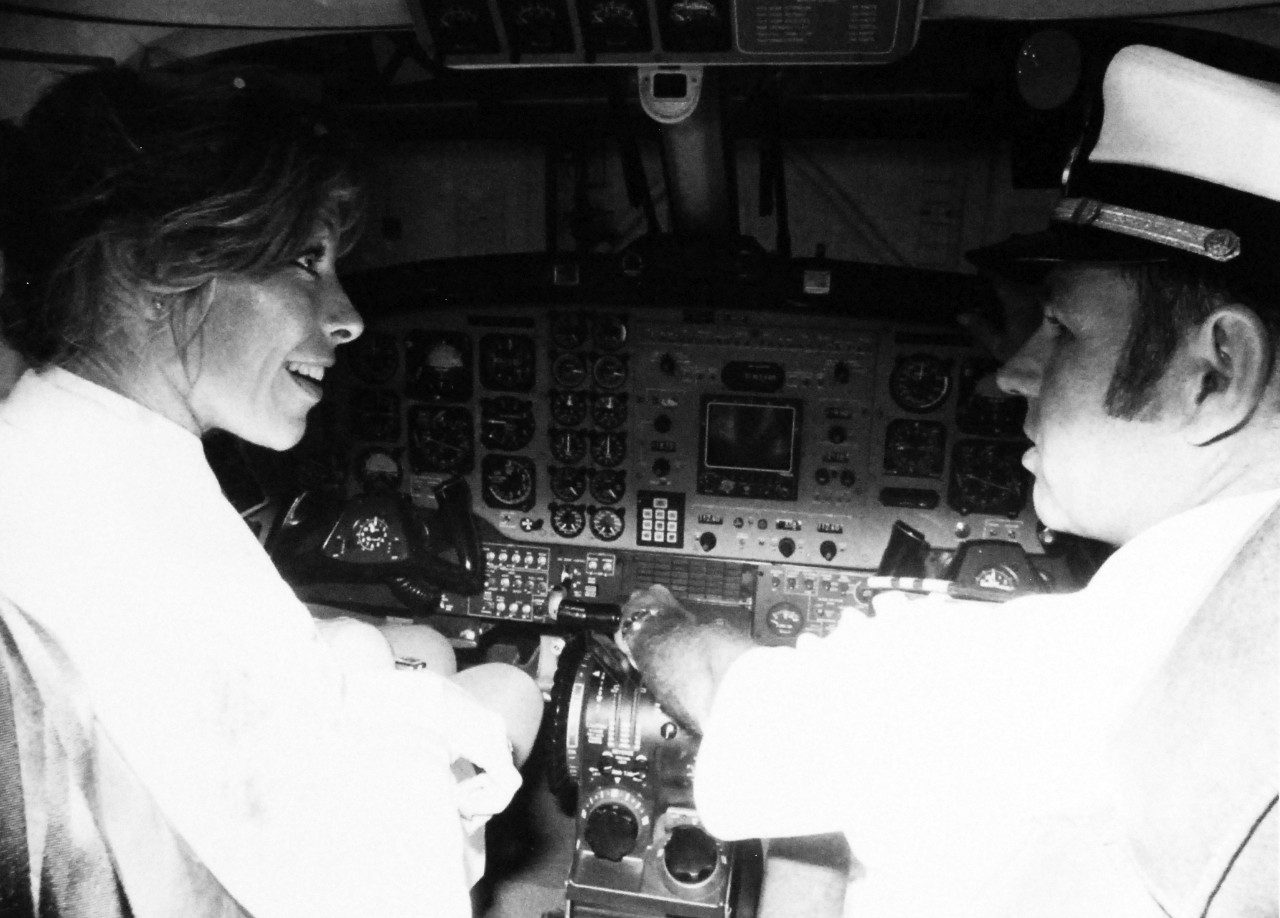428-GX-USN-1175823:  Lieutenant Donna Spruill, July 1979.   Spruill the first female pilot to make an arrested landing onboard an aircraft carrier in a C-1 trader checks out the cockpit of the UC-12B.  Lieutenant Harry Morrison, the first qualified UC-12B plane commander explains the details.   Photographed by JOC Russ Egnor, USNR-R, September 28, 1979.        U.S. Navy Photograph, now in the collections of the National Archives. 