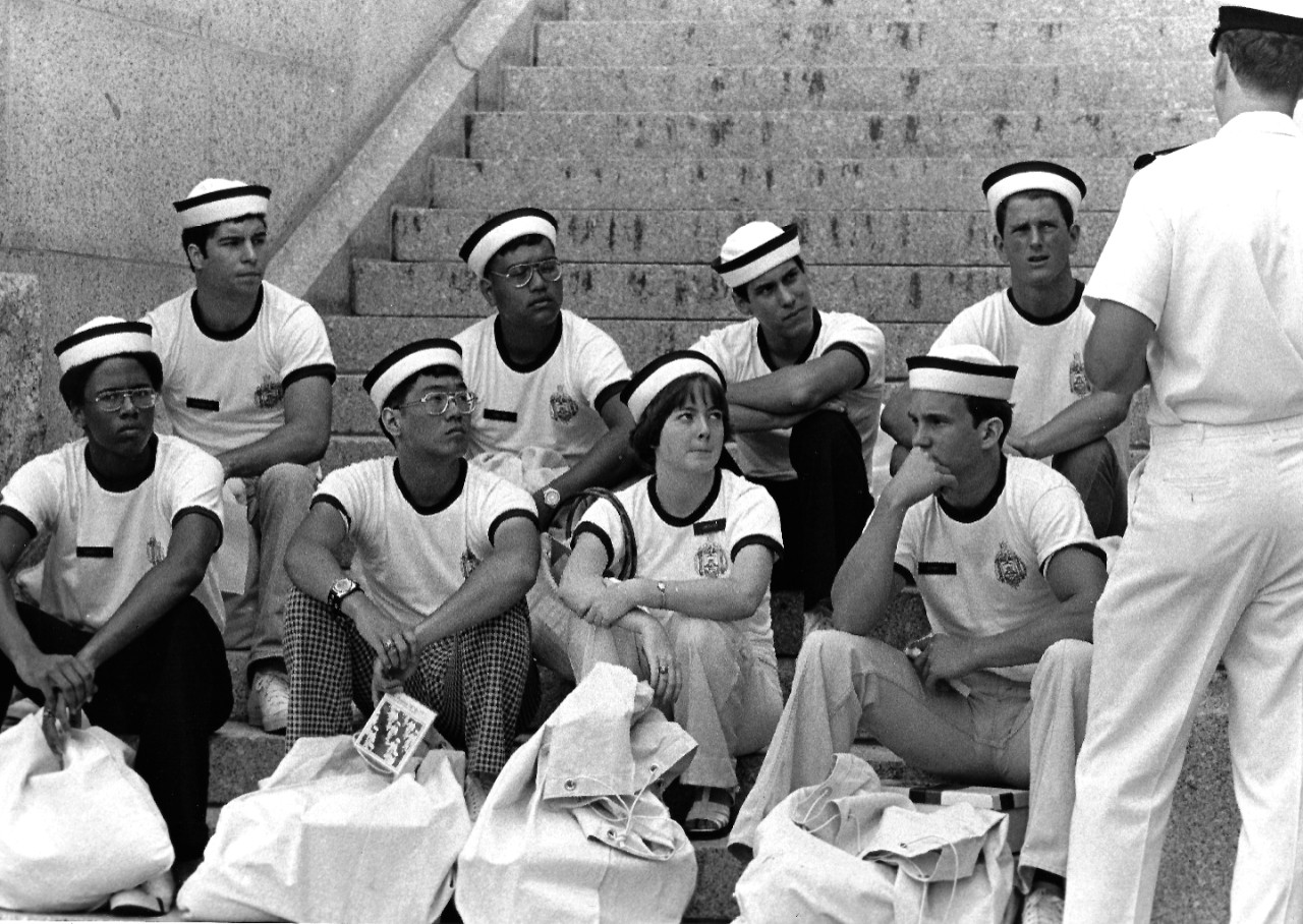 USN 1167430:   Woman Midshipman Smith, (center), July 1976.   Smith and male Midshipmen of the U.S. Naval Academy Class of 1980 listen to instructions as they are assigned to battalions, July 6, 1976.   Photographed by Erich J. Wirth.   Official U.S. Navy photograph, now in the collections of the National Archives.  
