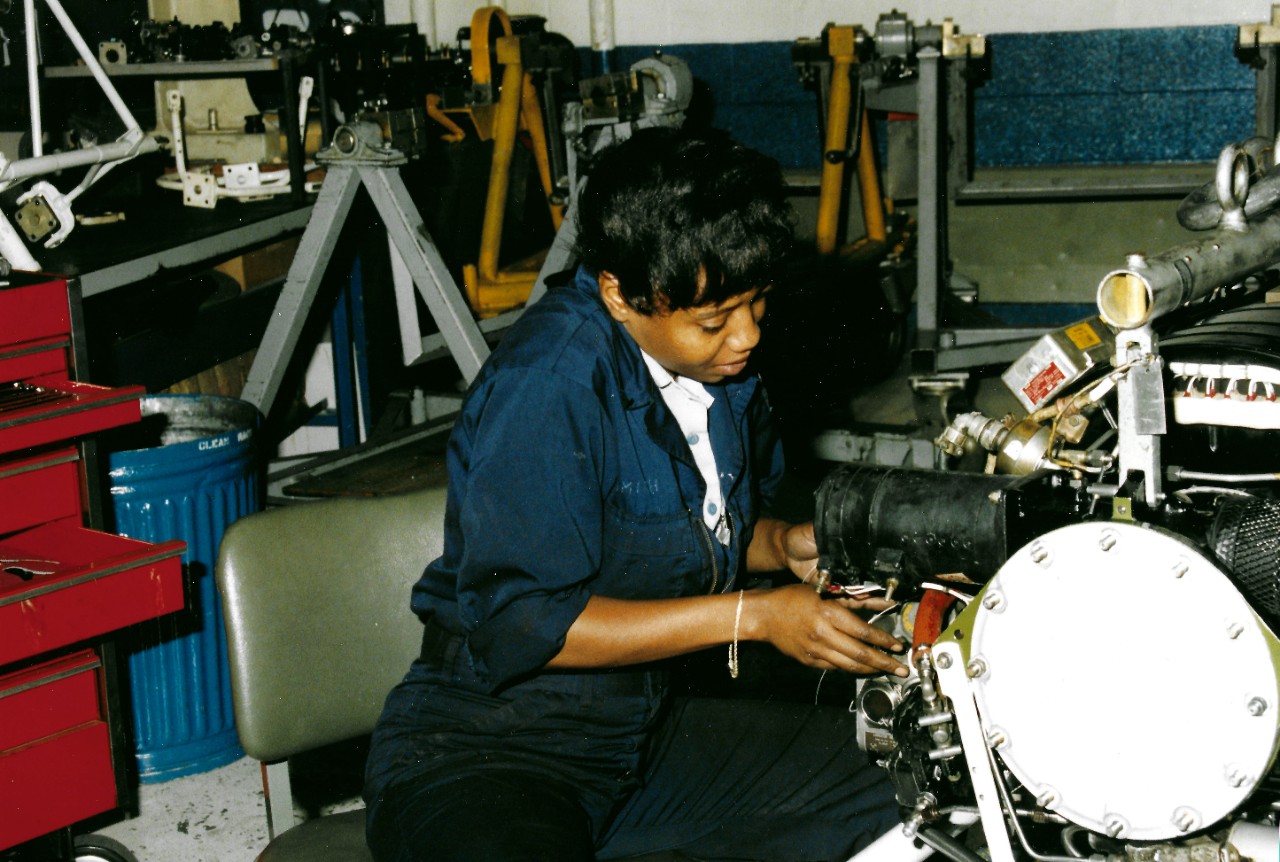 330-CFD-DN-SC-93-00253:   Aviation Machinist’s Mate Third Class Smith, August 1992.    Smith serves as aircraft engine component at Naval Air Station, Brunswick, Maine.  Photographed by PH2 Scruggs, August 28, 1992.  Official U.S. Navy Photograph, now in the collections of the National Archives.