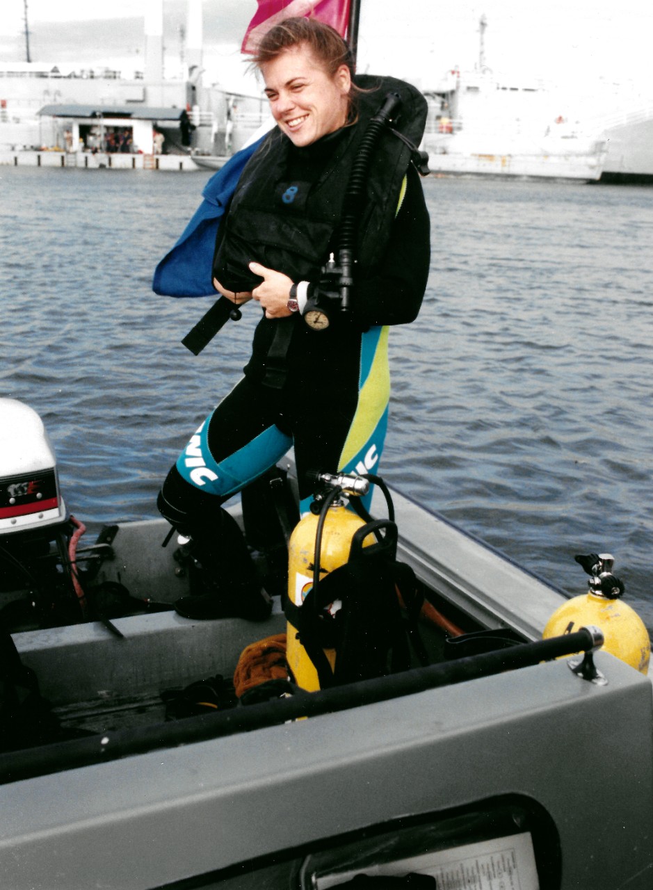 330-CFD-DN-SC-94-01712:  Photographer’s Mate Second Class (PH2) Malika Bean, February 1994.  Bean, the only female diver in a combat camera unit, prepares to go on a training dive.   Photographed by JO3 Wendy Hamme, February 1994.   Official U.S. Navy Photograph, now in the collections of the National Archives.  