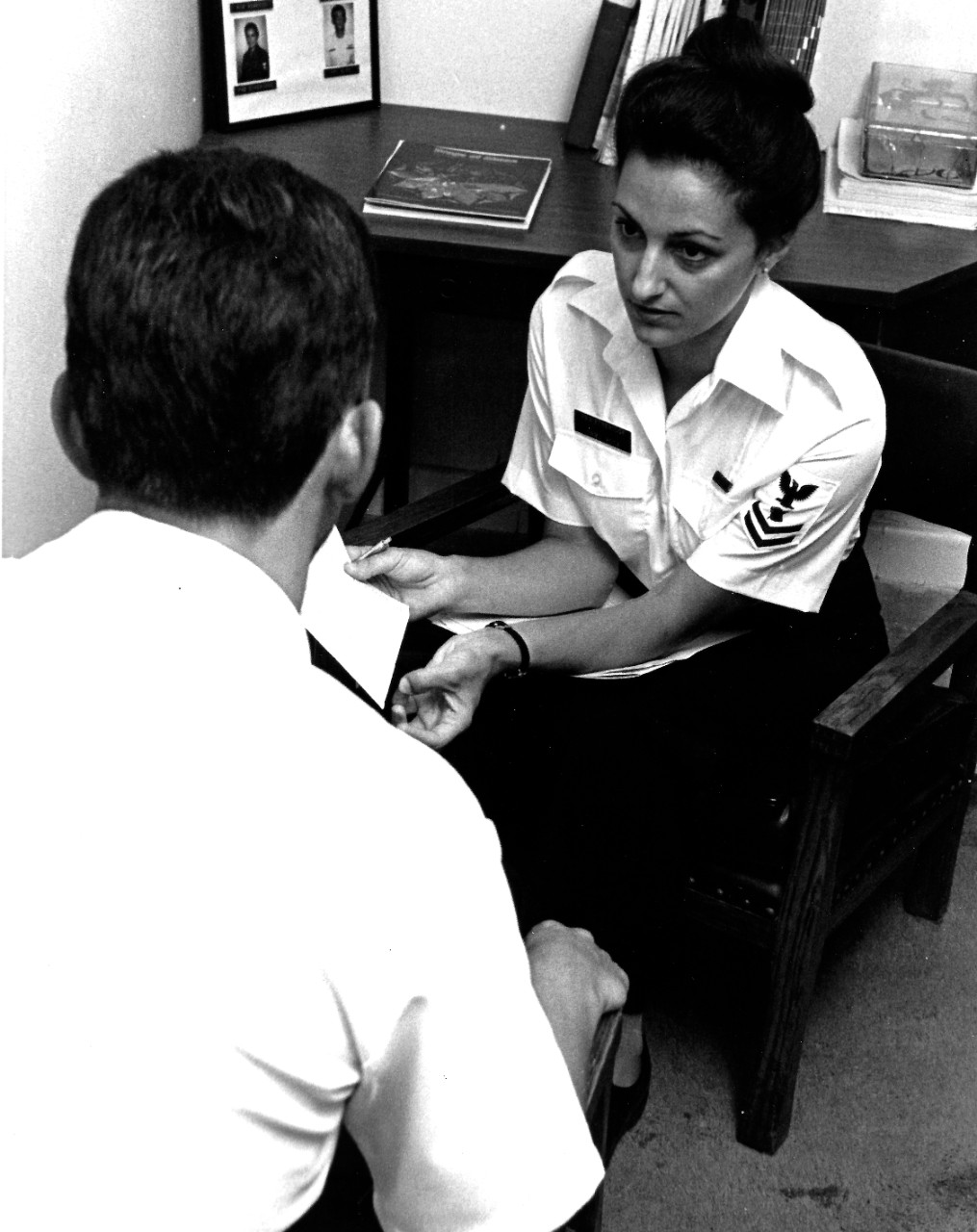 330-CFD-DN-SN-84-01330:   Petty Officer Second Class Kathy Russo Etheridge, February 1983.   Etheridge, a Drug and Alcohol Abuse Counselor, discusses problems with a Navy person seeking her help.  Photographed by PH1 Carolyn Harris, February 1, 1983.  Official U.S. Navy photograph, now in the collections of the National Archives.  