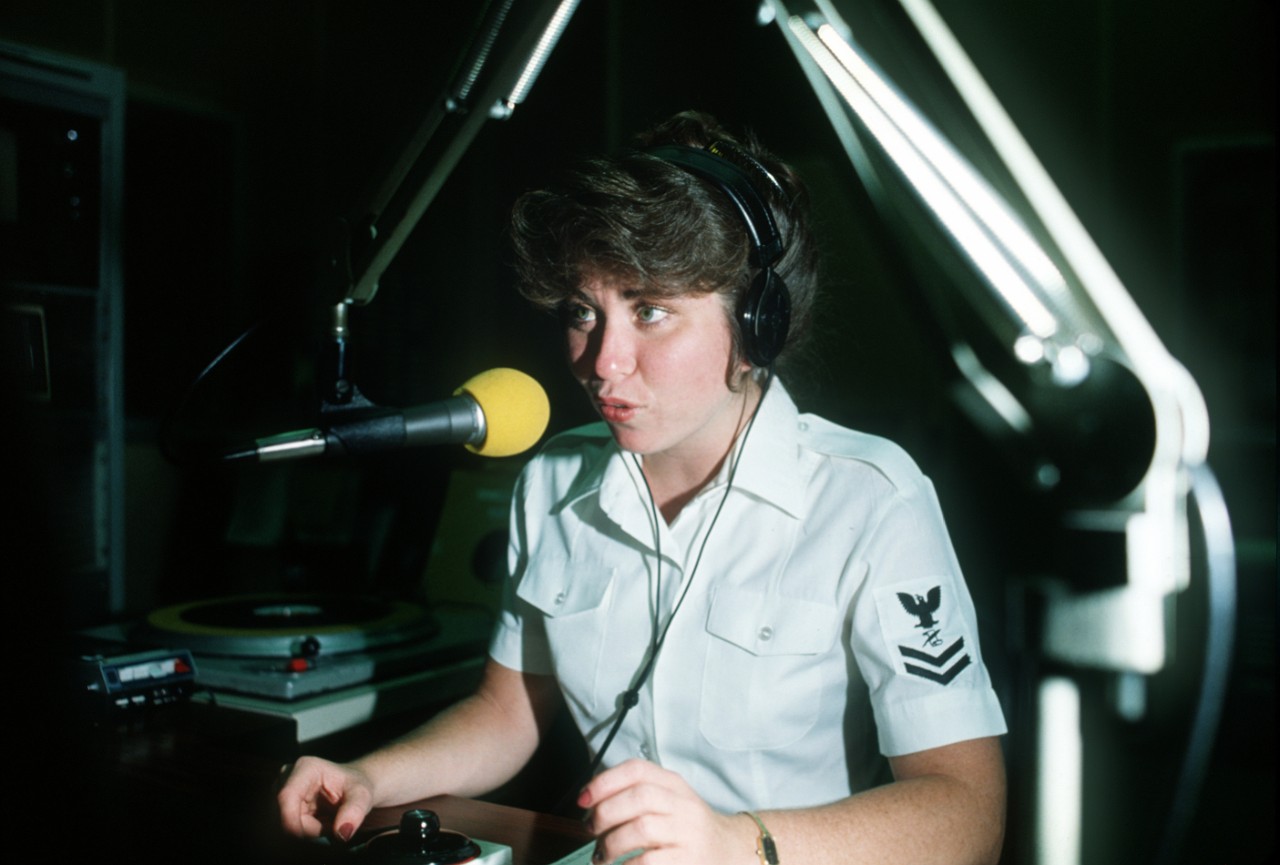 330-CFD-DN-ST-84-03503:   Journalist 2nd Class (JO2) Paula LeClaire, 1984.   LeClaire selects albums to be played over the airwaves at the Armed Forces Radio/Television Service Far East Network. Official U.S. Navy photograph, now in the collections of the National Archives.  