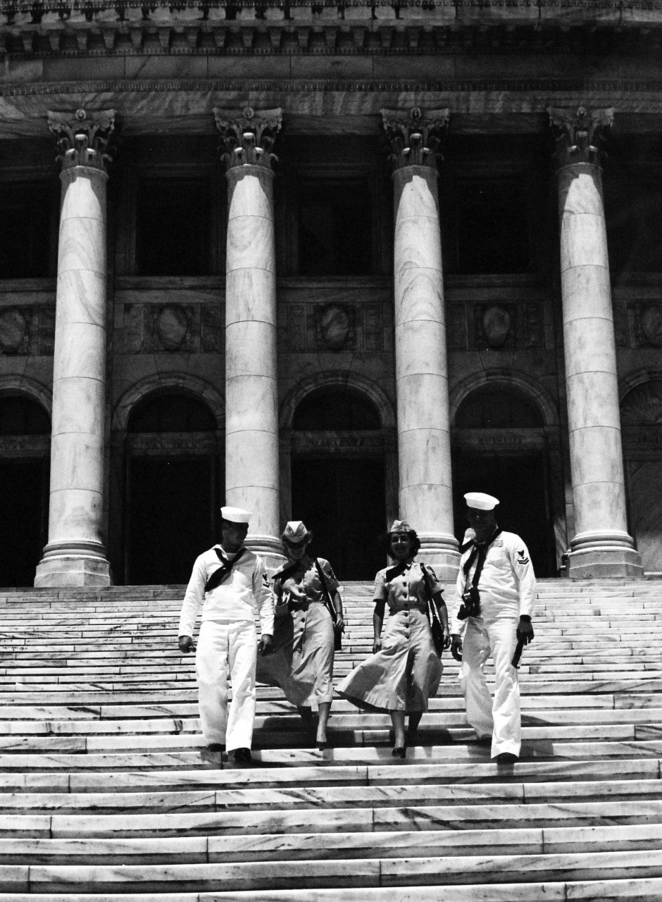 USN 709025:    The WAVES and their escorts pause to have their pictures taken for the folks back home, October 1953.  One of the last visits on their tour was Puerto Rico’s beautiful capitol building which is the home of both houses of the Insular Legislation and the Supreme Court.  Built of Georgia marble, this modern structure overlooks both the Atlantic Ocean and San Juan Bay.  Left to right:  Baker, Myers, Paluzzi, and LaFreniere.   Photograph released October 26, 1953.   Master Caption:   Navy Accepts Women Volunteers for Duty on the High Seas.   For the first time in history, the U.S. Navy has accepted volunteers for duty on the high seas from women in the enlisted WAVES.  Those eligible were WAVES of the Hospital Corps to fill sixty-three billets on ships of the Military Sea Transportation Service.   Official U.S. Navy photograph, now in the collections of the National Archives.   
