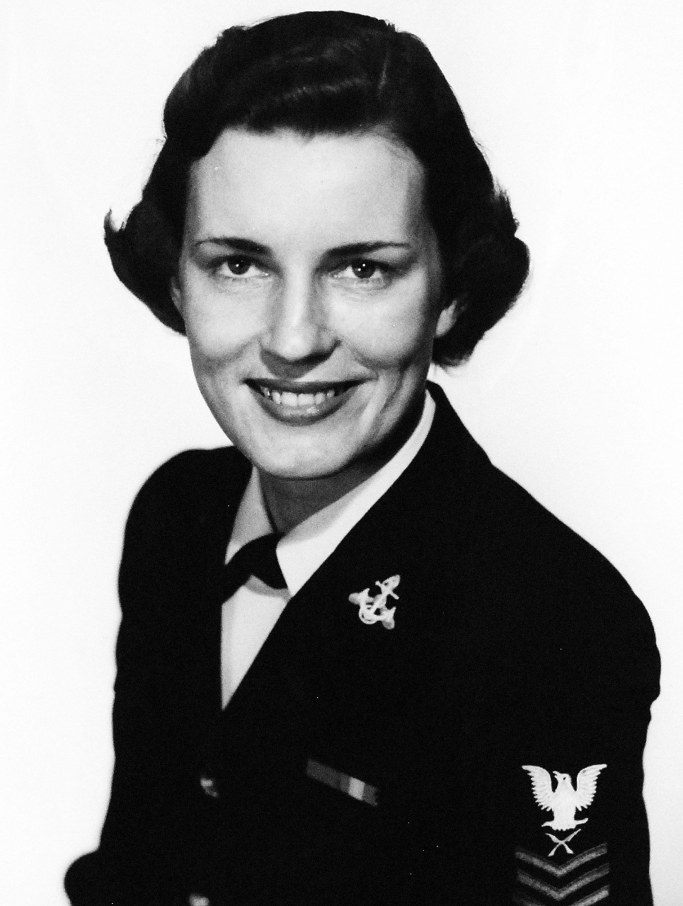 USN 709137:   Yeoman First Class Joan G. Mackie, March 1954.  One of the first two U.S. Navy enlisted WAVES to be selected for Officer Candidate School, March 1954.    Mackie will report to the school at Newport, Rhode Island in July.   Yeoman Mackie enlisted in the U.S. Navy in 1949 and since that time has served in Hawaii and France, as well as U.S. Bases.  In 1952, she became the first WAVE to be assigned to duty on the Staff of Supreme Allied Commander, Atlantic.  At the time of the photograph, Yeoman Mackie was on duty with the Bureau of Naval Personnel, Washington, D.C.   Photograph released March 15, 1954.  Official U.S. Navy photograph, now in the collections of the National Archives.   