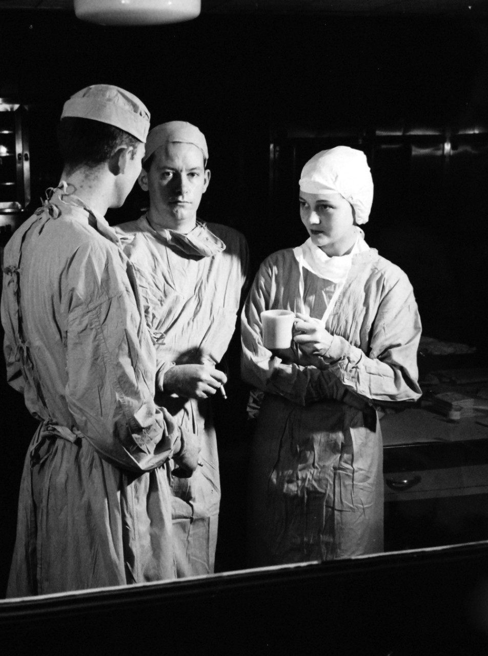 USN 709746:   A Navy Nurse at U.S. Naval Hospital, Bethesda, Maryland, January 1957.   Ensign Shirly M. Muse and two other highly important members of the Navy’s medical team take a breather following surgery at the U.S. Naval Hospital, Bethesda, Maryland.   Left to right are:  Hospital Corpsman Third Class Robert  S. Galebreath; Surgeon Lieutenant John J. Ring. Photograph released January 4, 1957.  Official U.S. Navy photograph, now in the collections of the National Archives.   
