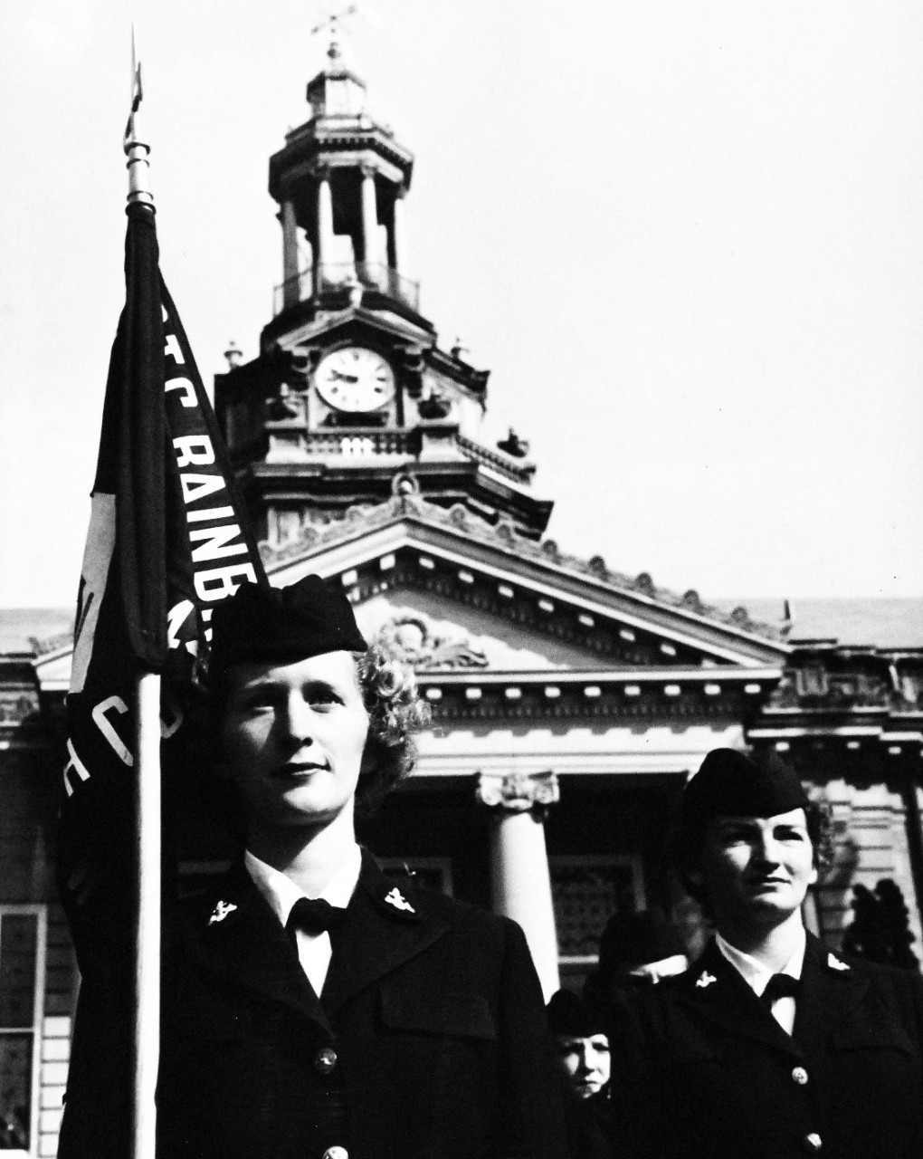 USN 708648:   Ten Years of the WAVY Blue, July 1952.     Recruit Company.  Recruit Petty Officer Second Class P. B. Schofield carries the guidon which marks her company during their training period.  The WAVES assemble each morning following their breakfast and muster (roll call) to march to their classes at the Naval Training Center, Bainbridge, Maryland.   Photograph released July 24, 1952.  Official U.S. Navy photograph, now in the collections of the National Archives.  