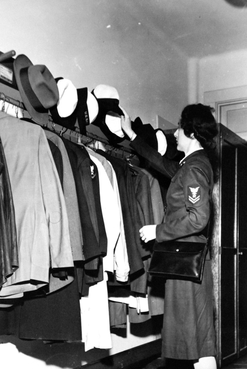 LC-USW3-30010-D:   A U.S. Navy Petty Officer Second Class WAVE, June 1943.  The petty officer hangs her hat at the American Red Cross blood donor center prior to giving blood to the bank, Washington, D.C.  Photograph by Ann Rosener, June 1943.  Office of War Information photograph.  Courtesy of the Library of Congress.  