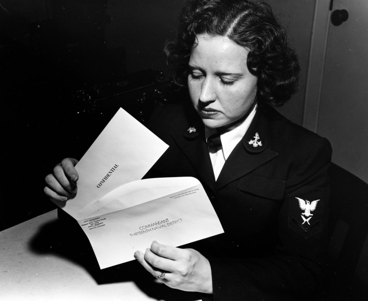 80-G-211166 :  Yeoman 3rd class Ida Sykes, USNR, September 1943.   Places a Confidential letter in its outer envelope, in an office at the Advanced Naval Training Station, Lake Union, Seattle, Washington, 1 September 1943. The envelope is addressed to the Commandant, Thirteenth Naval District. Official U.S. Navy Photograph, now in the collections of the National Archives.   