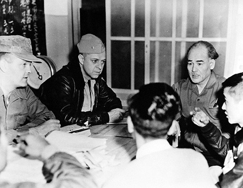 330-PS-9308-1: U.S. Navy Aids Japanese Fire Victims, December 1958. Koniya, Japan. Shown: Unidentified Seventh Fleet personnel discussing the situation with local Japanese. Official U.S. Navy Photograph, now in the collections of the National Arc...
